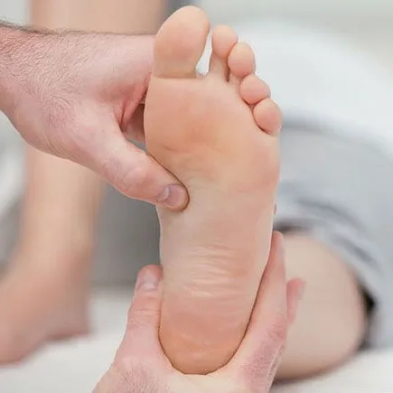 Diabetic Foot Care Routine: A person with diabetes inspecting their feet for signs of ulcers or injuries.
